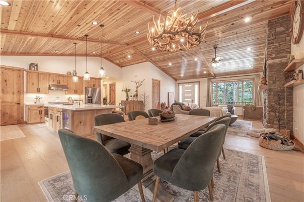 Chandelier, Dining room, Fireplace, Interior, Kitchen, Living room, Pendant Lights, Recessed Lighting, Stainless Steel Appliances, Stone Walls, Wooden Beams, Wooden Ceilings, Wood Texture Flooring