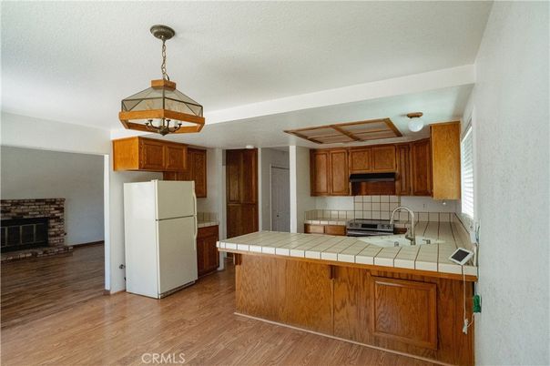 Fireplace, Interior, Kitchen, Pendant Lights, Tile Countertops, Wood Texture Flooring