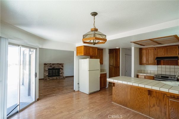 Fireplace, Interior, Kitchen, Pendant Lights, Tile Countertops, Wood Texture Flooring