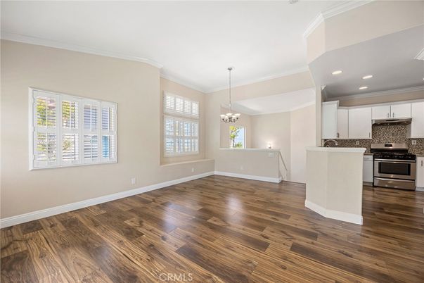 Chandelier, Empty room, Interior, Kitchen, Recessed Lighting, Stainless Steel Appliances, Wood Texture Flooring