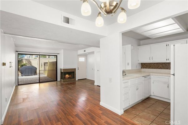 Empty room, Fireplace, Interior, Kitchen, Pendant Lights, Wood Texture Flooring