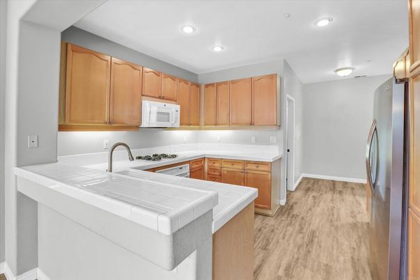 Interior, Kitchen, Recessed Lighting, Tile Countertops, Wood Texture Flooring