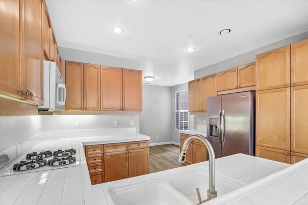 Interior, Kitchen, Recessed Lighting, Tile Countertops, Wood Texture Flooring