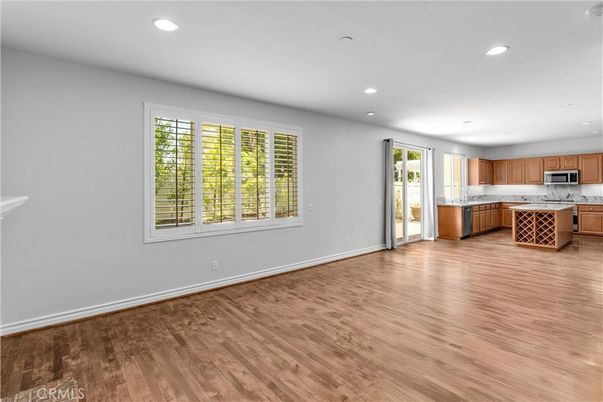 Empty room, Interior, Kitchen, Recessed Lighting, Stainless Steel Appliances, Wood Texture Flooring