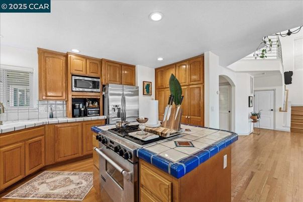 Interior, Kitchen, Recessed Lighting, Stainless Steel Appliances, Tile Countertops, Wood Texture Flooring