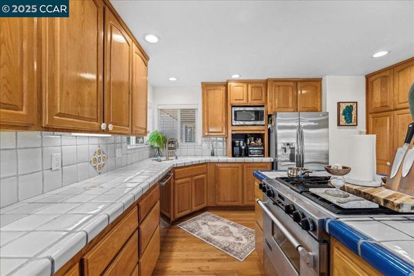 Interior, Kitchen, Recessed Lighting, Stainless Steel Appliances, Tile Countertops, Wood Texture Flooring