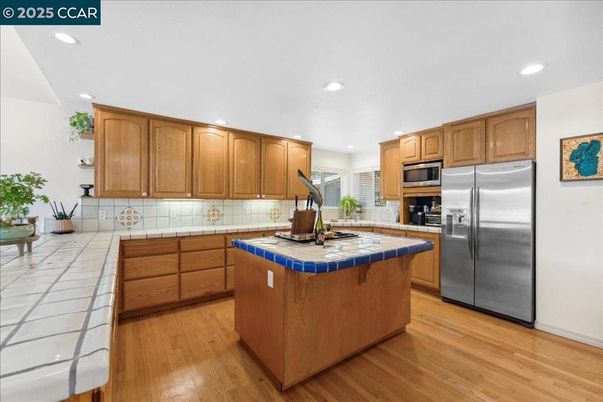 Interior, Kitchen, Recessed Lighting, Stainless Steel Appliances, Tile Countertops, Wood Texture Flooring