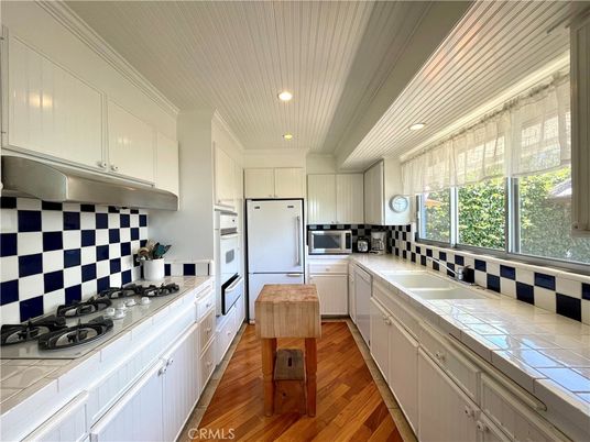 Interior, Kitchen, Recessed Lighting, Stainless Steel Appliances, Tile Countertops, Wood Texture Flooring