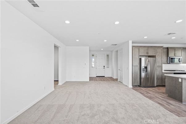 Empty room, Interior, Kitchen, Recessed Lighting, Stainless Steel Appliances, Wood Texture Flooring