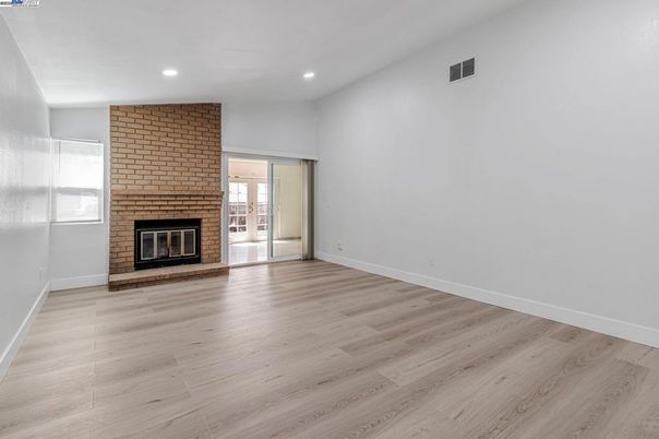 Empty room, Fireplace, Interior, Recessed Lighting, Stone Walls, Wood Texture Flooring