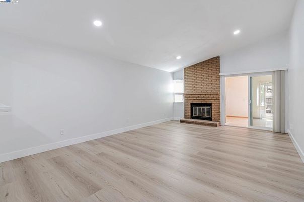 Empty room, Fireplace, Interior, Recessed Lighting, Stone Walls, Wood Texture Flooring