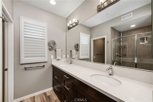 Bathroom, Dual Sink Vanities, Glass Shower, Interior, Recessed Lighting, Wood Texture Flooring