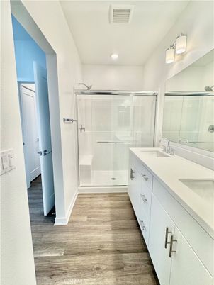 Bathroom, Dual Sink Vanities, Glass Shower, Interior, Recessed Lighting, Wood Texture Flooring