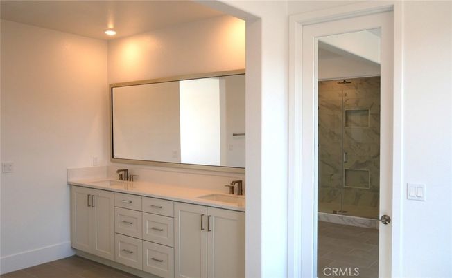 Bathroom, Dual Sink Vanities, Glass Shower, Interior, Marble Walls, Recessed Lighting
