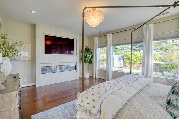 Bedroom, Chandelier, Fireplace, Interior, Recessed Lighting, Wood Texture Flooring