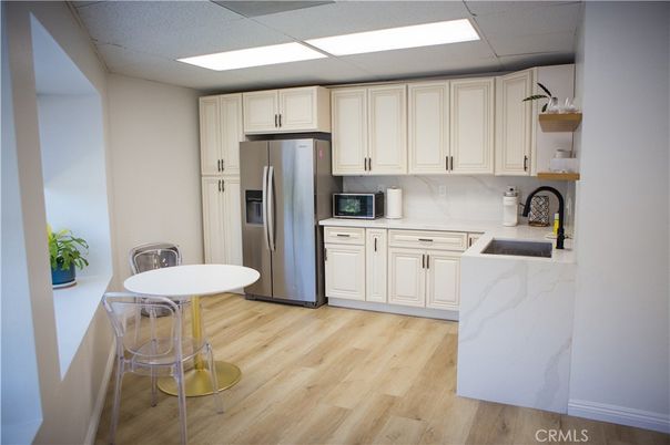 Interior, Kitchen, Marble Walls, Recessed Lighting, Stainless Steel Appliances, Wood Texture Flooring