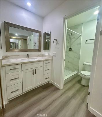 Bathroom, Dual Sink Vanities, Glass Shower, Interior, Marble, Marble Walls, Recessed Lighting, Wood Texture Flooring