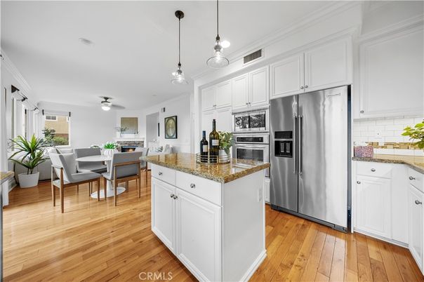 Dining room, Fireplace, Interior, Kitchen, Pendant Lights, Stainless Steel Appliances, Wood Texture Flooring