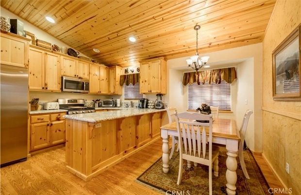Chandelier, Dining room, Interior, Kitchen, Recessed Lighting, Stainless Steel Appliances, Wooden Ceilings, Wood Texture Flooring
