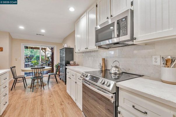 Dining room, Interior, Kitchen, Recessed Lighting, Stainless Steel Appliances, Wood Texture Flooring