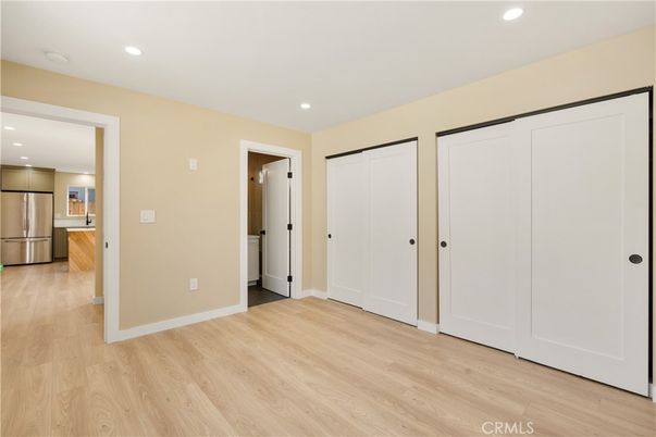 Empty room, Interior, Kitchen, Recessed Lighting, Stainless Steel Appliances, Wood Texture Flooring