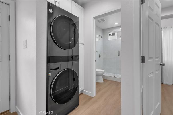 Bathroom, Glass Shower, Interior, Recessed Lighting, Utility Closets, Washer, Wood Texture Flooring