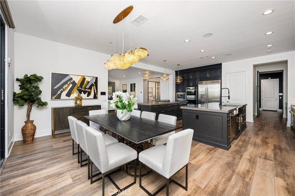 Chandelier, Dining room, Interior, Kitchen, Pendant Lights, Recessed Lighting, Stainless Steel Appliances, Wood Texture Flooring