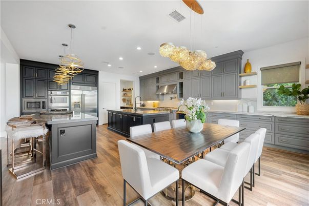 Chandelier, Dining room, Interior, Kitchen, Pendant Lights, Recessed Lighting, Stainless Steel Appliances, Wood Texture Flooring