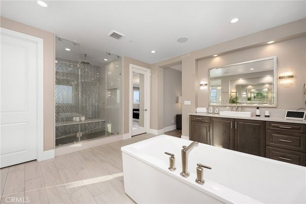 Bathroom, Dual Sink Vanities, Free Standing Baths, Glass Shower, Interior, Recessed Lighting, Wood Texture Flooring
