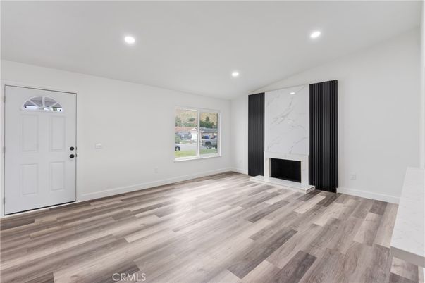 Empty room, Fireplace, Interior, Marble Walls, Recessed Lighting, Wood Texture Flooring