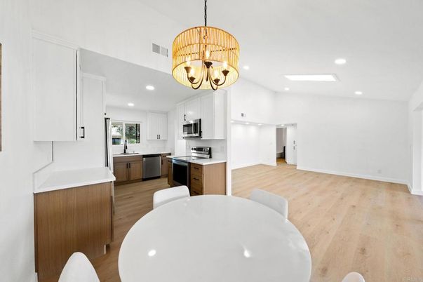 Chandelier, Dining room, Interior, Kitchen, Recessed Lighting, Stainless Steel Appliances, Wood Texture Flooring