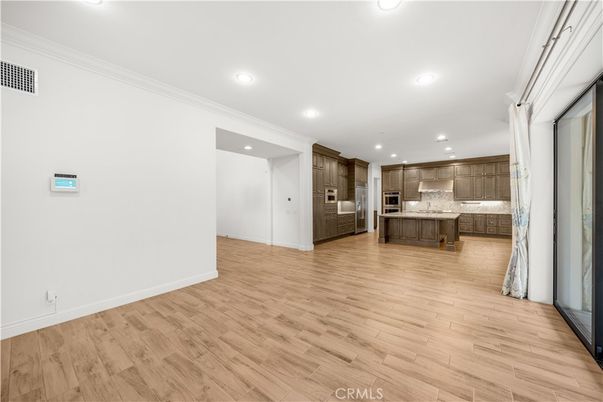 Empty room, Interior, Kitchen, Recessed Lighting, Stainless Steel Appliances, Wood Texture Flooring