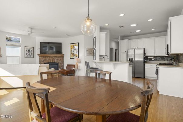 Dining room, Fireplace, Interior, Kitchen, Pendant Lights, Recessed Lighting, Stainless Steel Appliances, Wood Texture Flooring