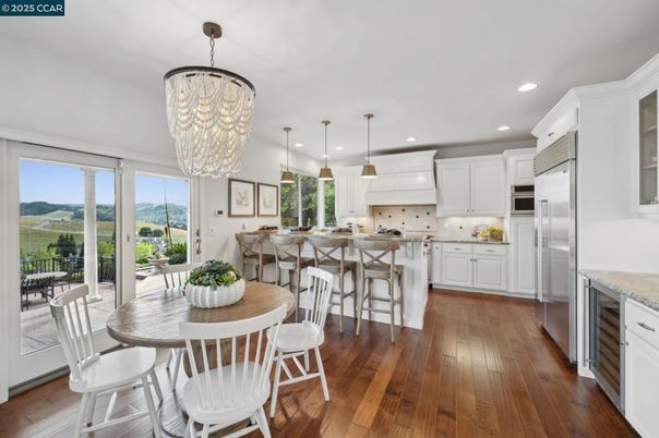 Chandelier, Dining room, Interior, Kitchen, Pendant Lights, Recessed Lighting, Stainless Steel Appliances, Wood Texture Flooring