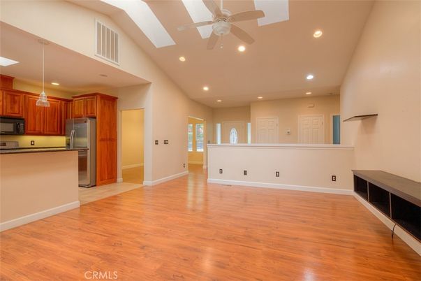 Empty room, Interior, Kitchen, Recessed Lighting, Stainless Steel Appliances, Wood Texture Flooring