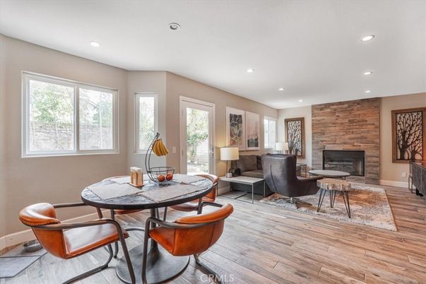 Dining room, Fireplace, Interior, Living room, Recessed Lighting, Stone Walls, Wood Texture Flooring