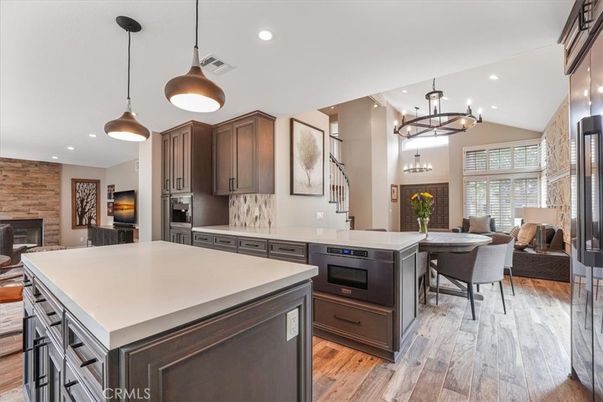 Dining room, Fireplace, Interior, Kitchen, Pendant Lights, Recessed Lighting, Stainless Steel Appliances, Wood Texture Flooring