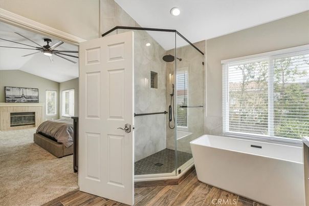 Bathroom, Fireplace, Free Standing Baths, Glass Shower, Interior, Marble Walls, Recessed Lighting, Wood Texture Flooring