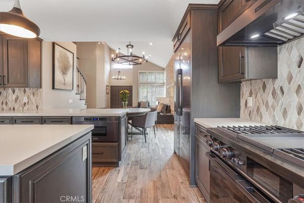 Chandelier, Dining room, Interior, Kitchen, Pendant Lights, Recessed Lighting, Stainless Steel Appliances, Wood Texture Flooring