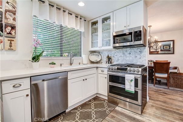 Chandelier, Dining room, Interior, Kitchen, Pendant Lights, Recessed Lighting, Stainless Steel Appliances, Wood Texture Flooring