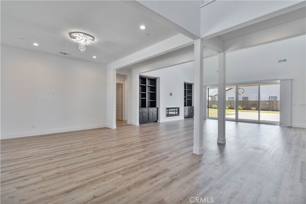 Chandelier, Empty room, Fireplace, Interior, Recessed Lighting, Wood Texture Flooring