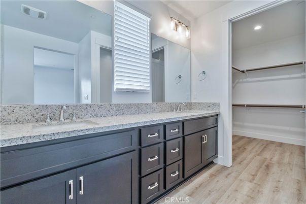 Bathroom, Dual Sink Vanities, Interior, Recessed Lighting, Walk-in Closets, Wood Texture Flooring