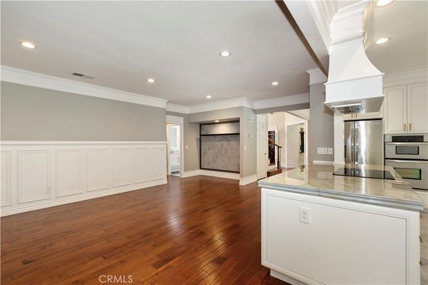 Empty room, Interior, Kitchen, Recessed Lighting, Stainless Steel Appliances, Wood Texture Flooring