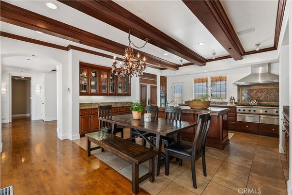 Chandelier, Dining room, Interior, Kitchen, Recessed Lighting, Stainless Steel Appliances, Wooden Beams, Wood Texture Flooring