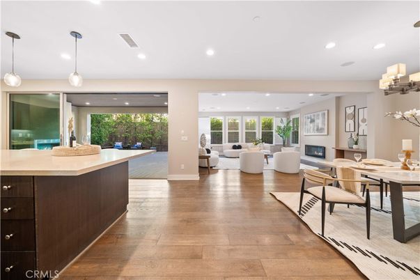 Dining room, Fireplace, Interior, Living room, Pendant Lights, Recessed Lighting, Wood Texture Flooring