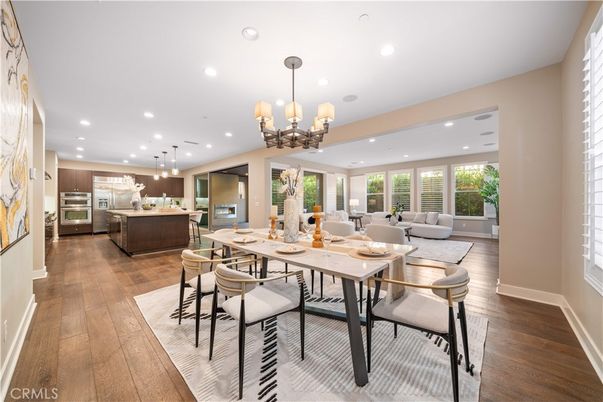 Chandelier, Dining room, Interior, Kitchen, Living room, Pendant Lights, Recessed Lighting, Stainless Steel Appliances, Wood Texture Flooring