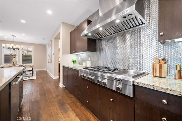 Chandelier, Dining room, Interior, Kitchen, Pendant Lights, Recessed Lighting, Stainless Steel Appliances, Wood Texture Flooring