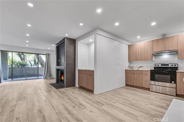 Fireplace, Interior, Kitchen, Recessed Lighting, Stainless Steel Appliances, Wood Texture Flooring