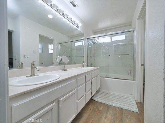 Bathroom, Dual Sink Vanities, Glass Shower, Interior, Marble Walls, Wood Texture Flooring