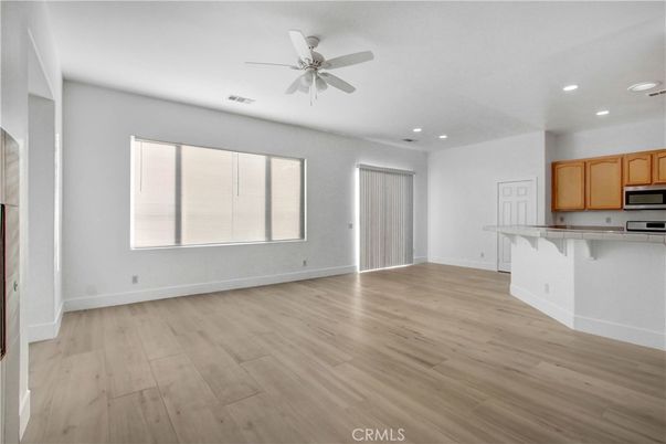 Empty room, Interior, Kitchen, Recessed Lighting, Stainless Steel Appliances, Wood Texture Flooring